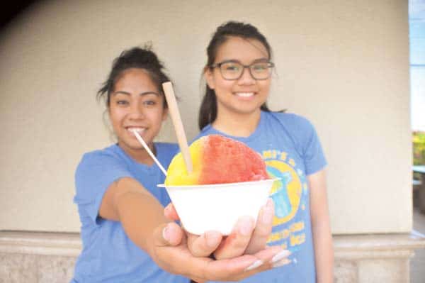 Two servers holding shave ice